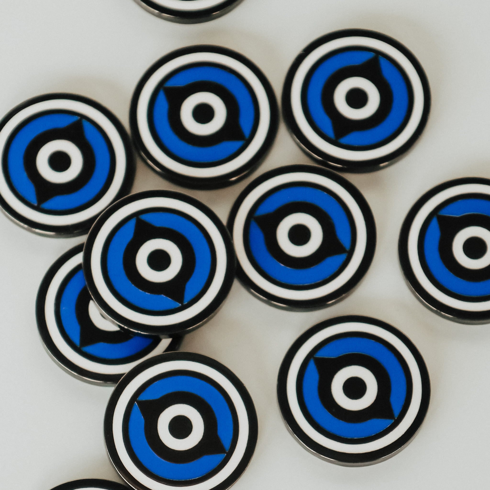 Overhead view of multiple Fore Eye ball markers showing glossy enamel finish and circular design repetition.