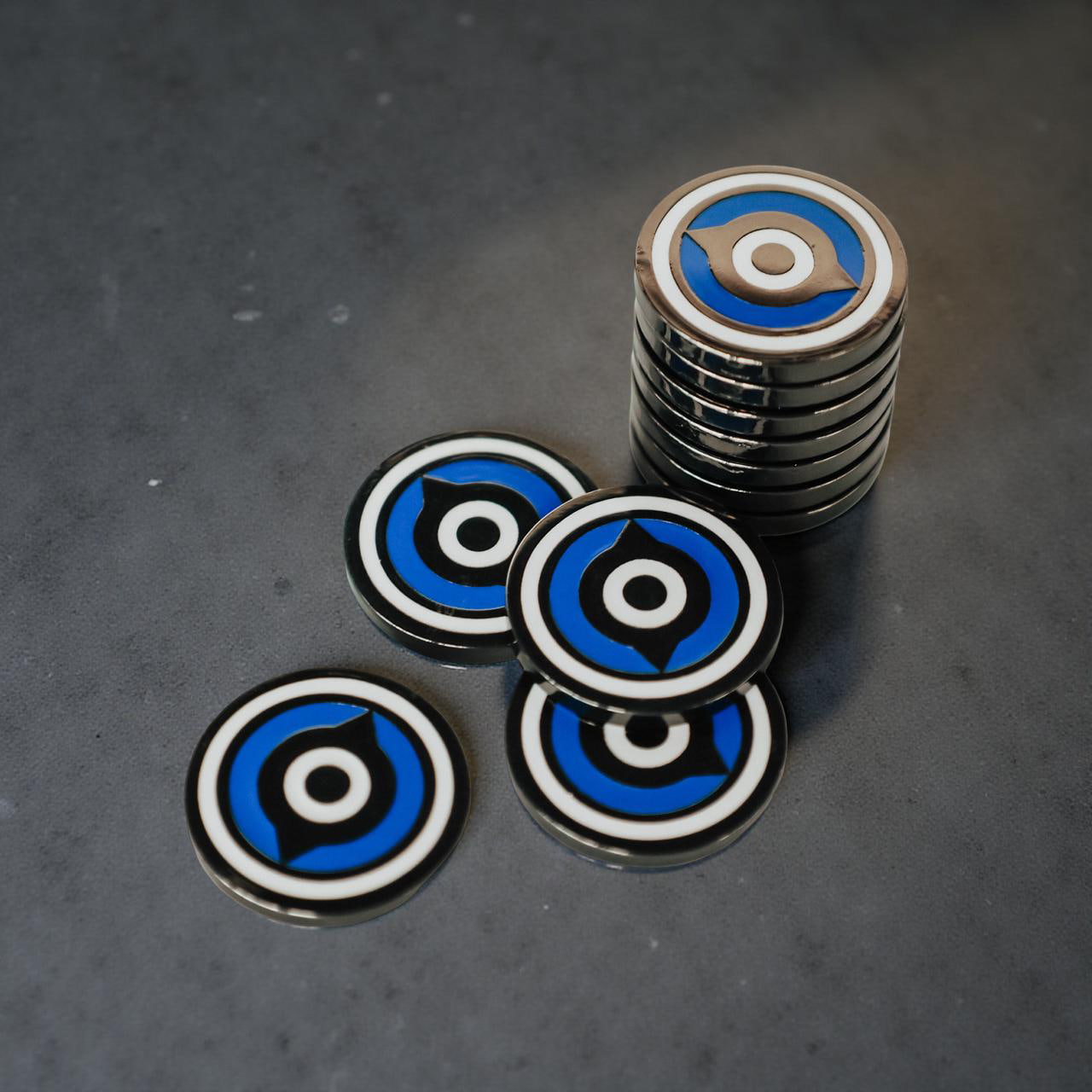 Custom golf ball markers by Caddy Collective Culture displayed on green turf, showcasing premium design and craftsmanship.