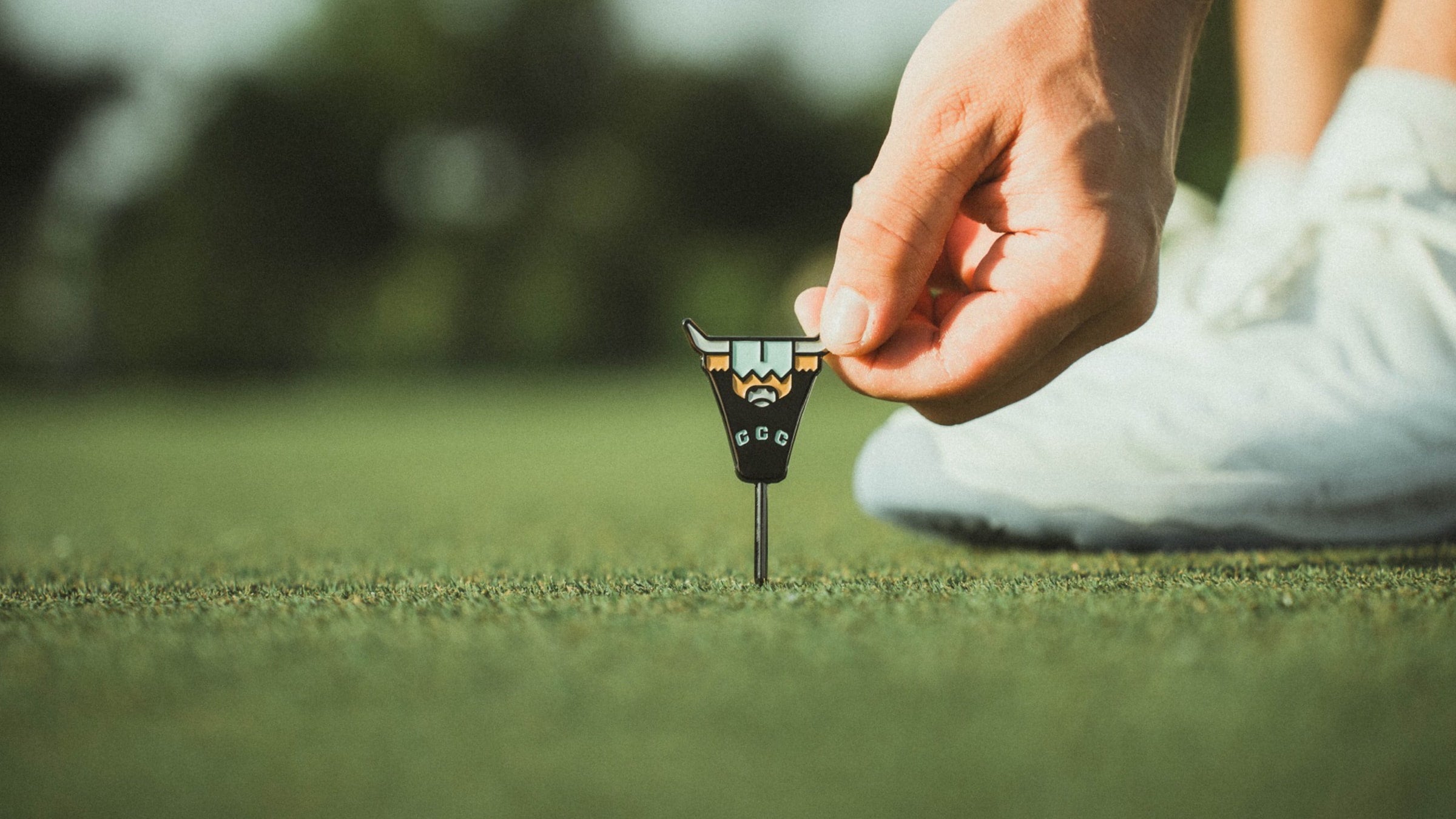 Caddy Collective Culture Looper single prong divot tool repairing a golf green during play.