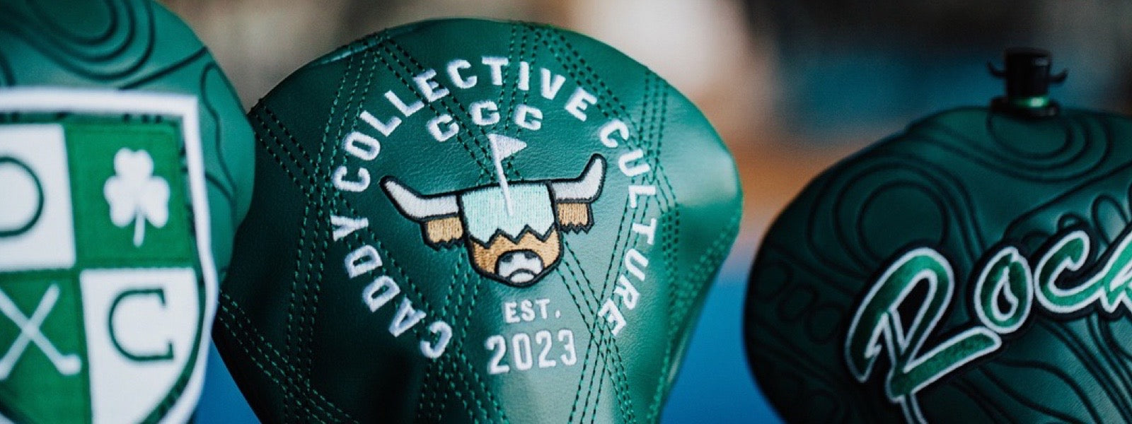 Caddy Collective handcrafted golf headcovers featuring signature green leather designs and embroidered logos, displayed as the hero image for The Loop golf journal.