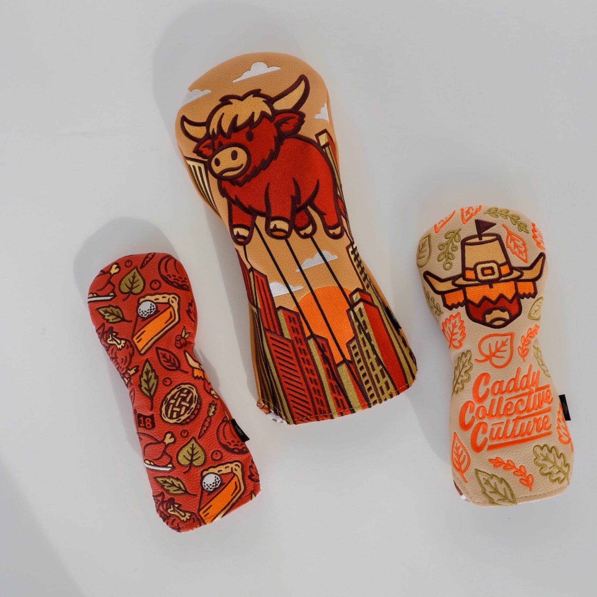 Autumn Feast hybrid headcover next to Pilgrim Looper and Harvest Parade designs on a clean white background.