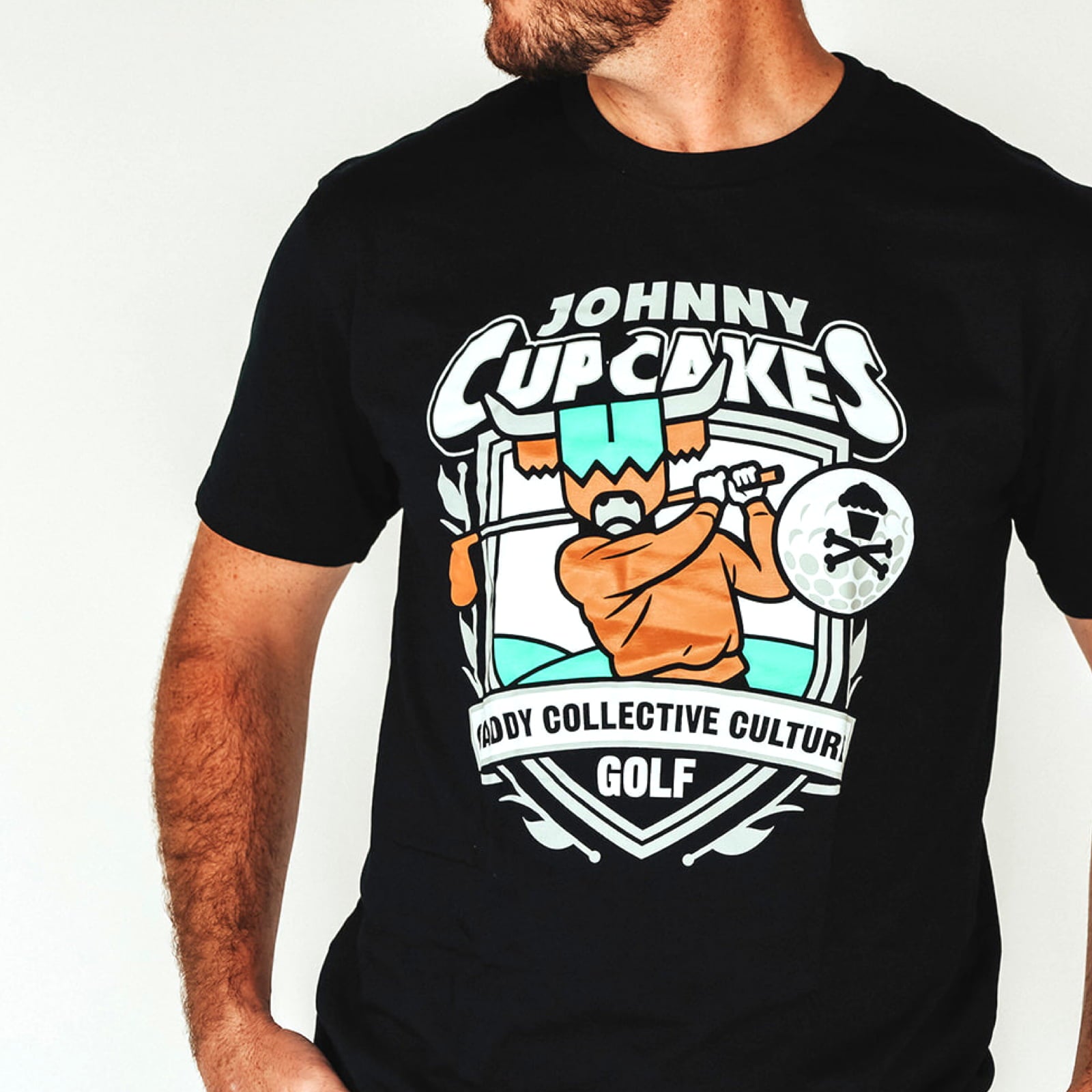 Close-up of Johnny Cupcakes x CCC golf T-shirt graphic design on chest golf shirt