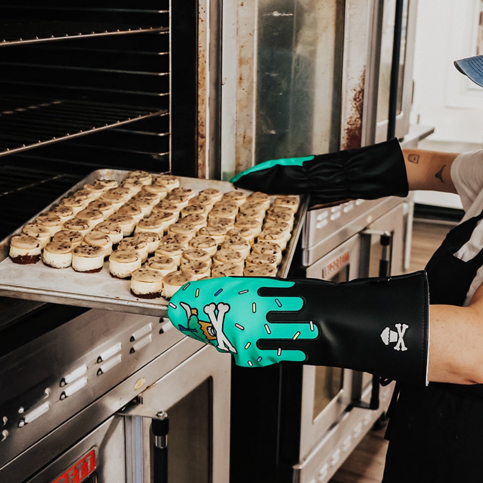 Johnny Cupcakes x Caddy Collective Culture golf driver headcover with sprinkle cupcake design, used as oven mitt while baking mini cheesecakes.