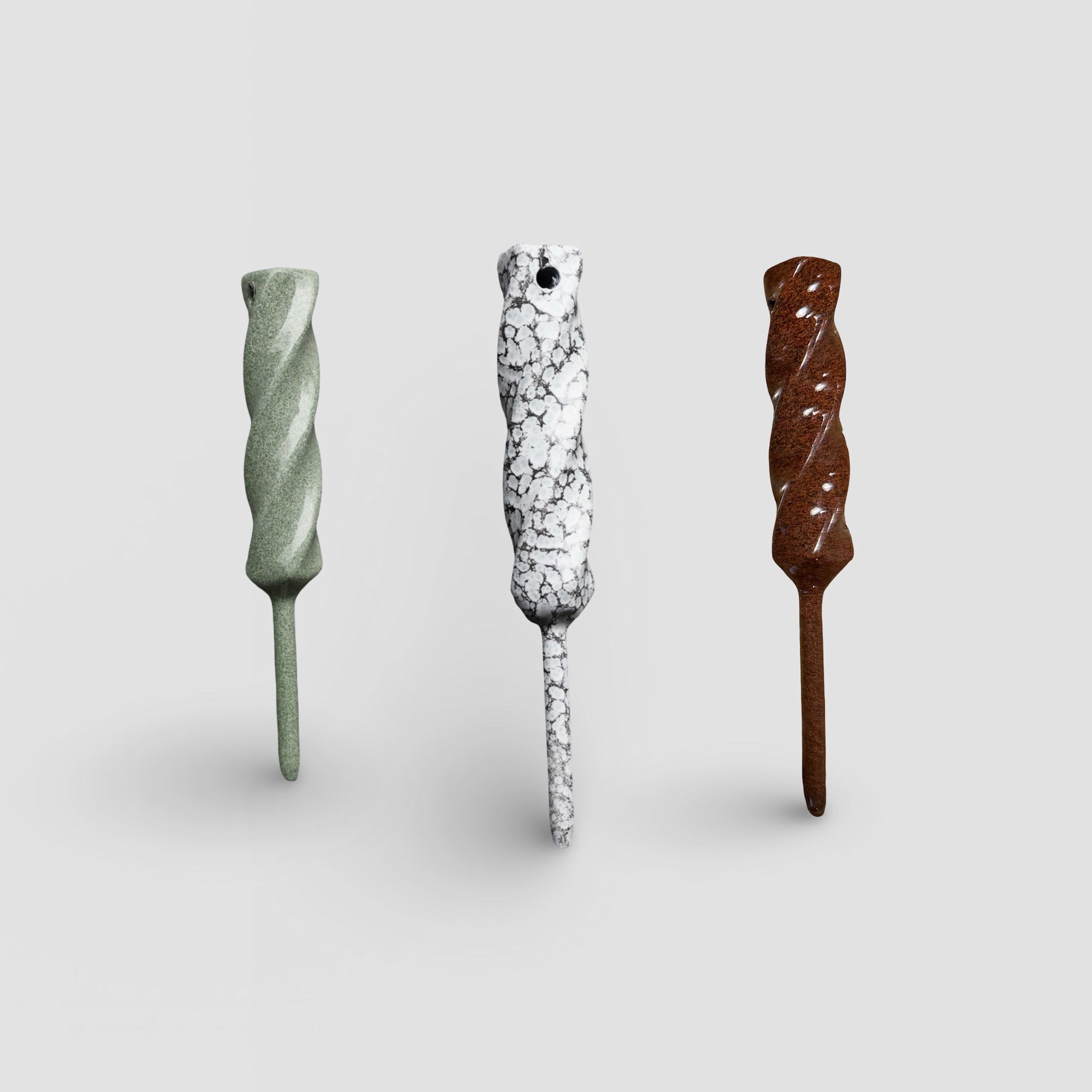 Dual-Twist divot tools shown together in Ithaca Bronze, Palleon White, and Rustic finishes