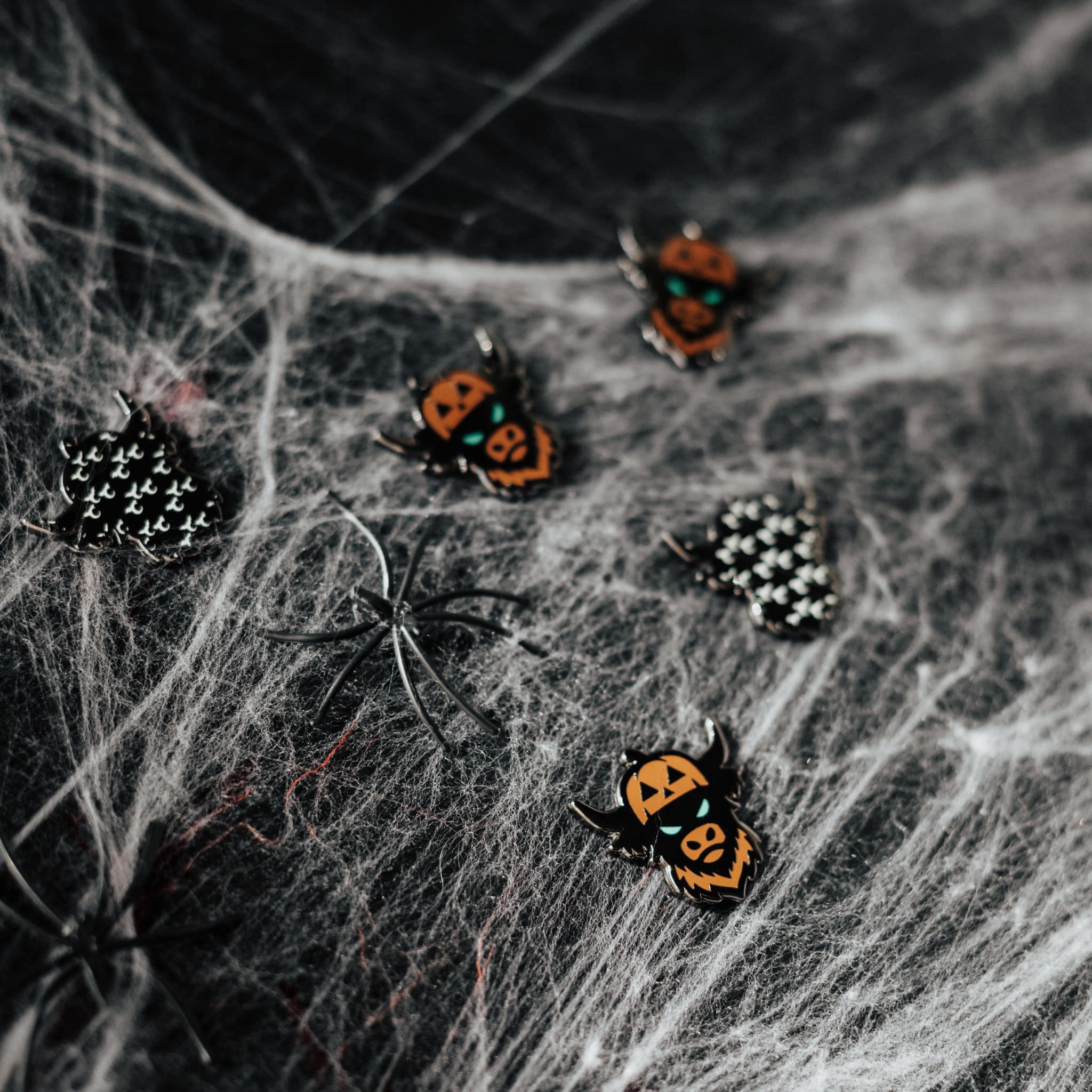 Looper After Dark ball markers displayed on spiderweb Halloween background with black spider