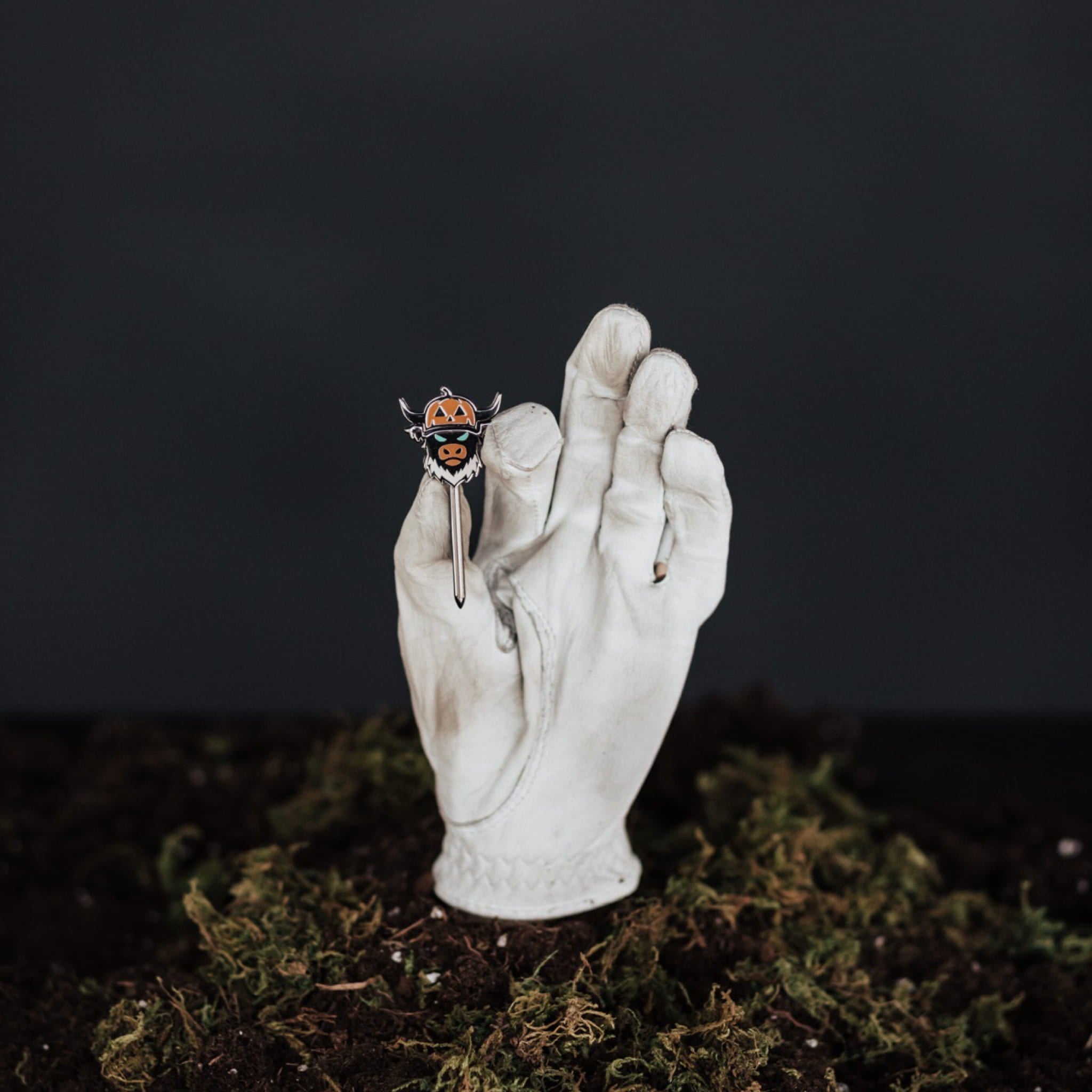 Looper After Dark combo tool held in hand showing black metal finish and pumpkin Looper design