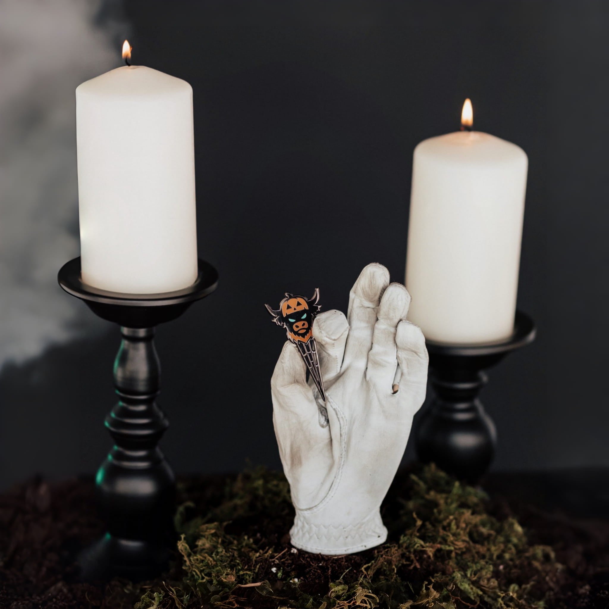 Looper After Dark Halloween divot tool collection displayed in moody candlelit setting