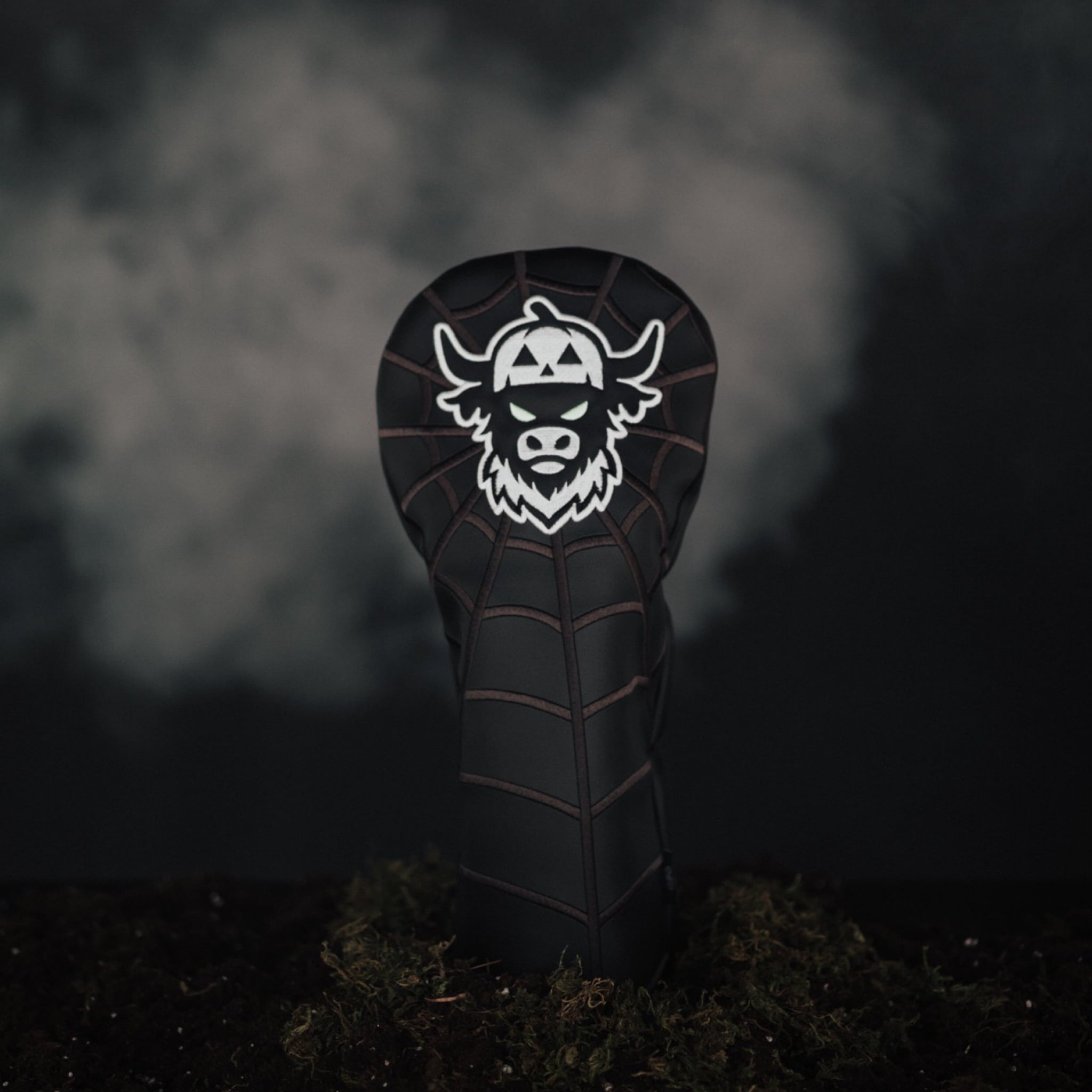 Looper After Dark driver headcover placed on moss in eerie Halloween scene