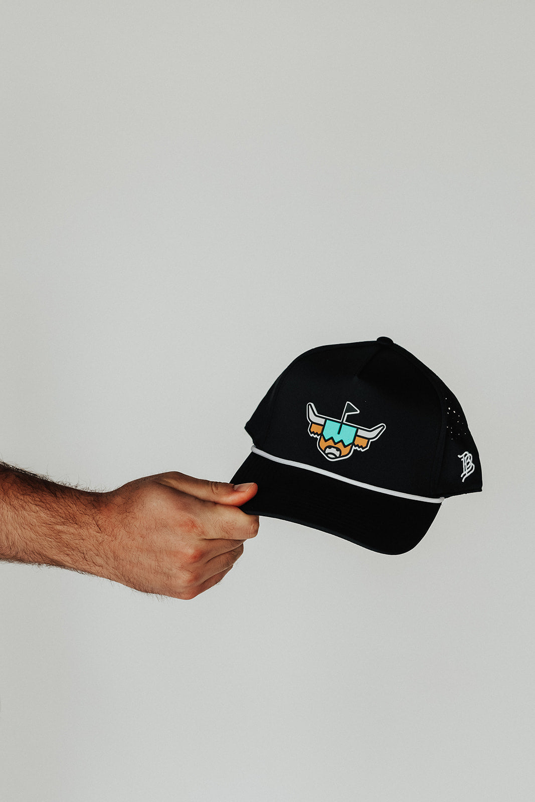 Looper Rope Hat held by hand, displaying logo, rope accent, and hat structure.