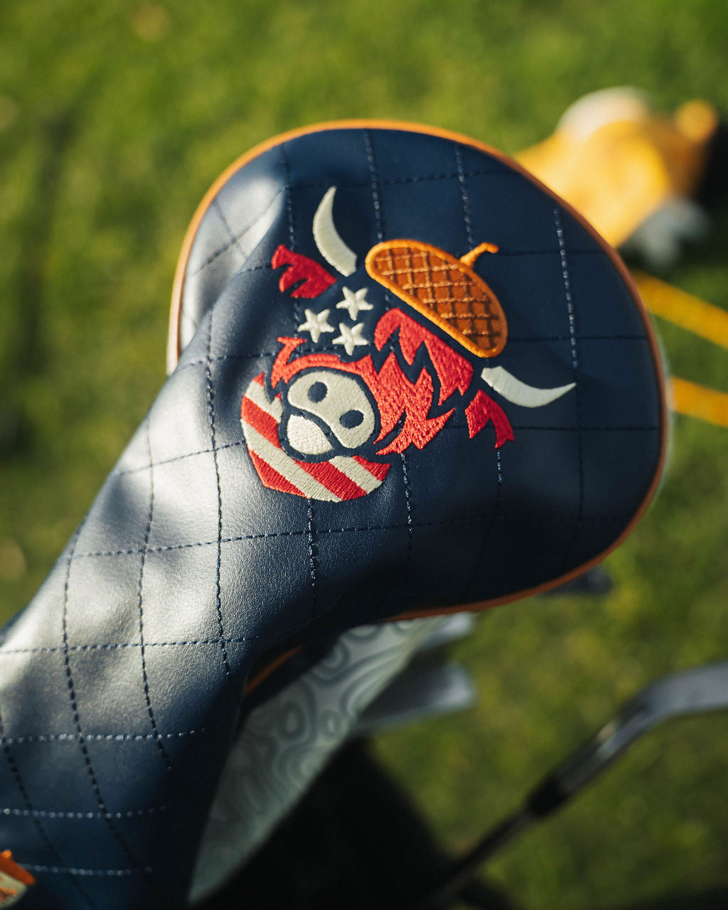 Close-up of detailed stitching on Oakmont driver headcover showing patriotic color accents