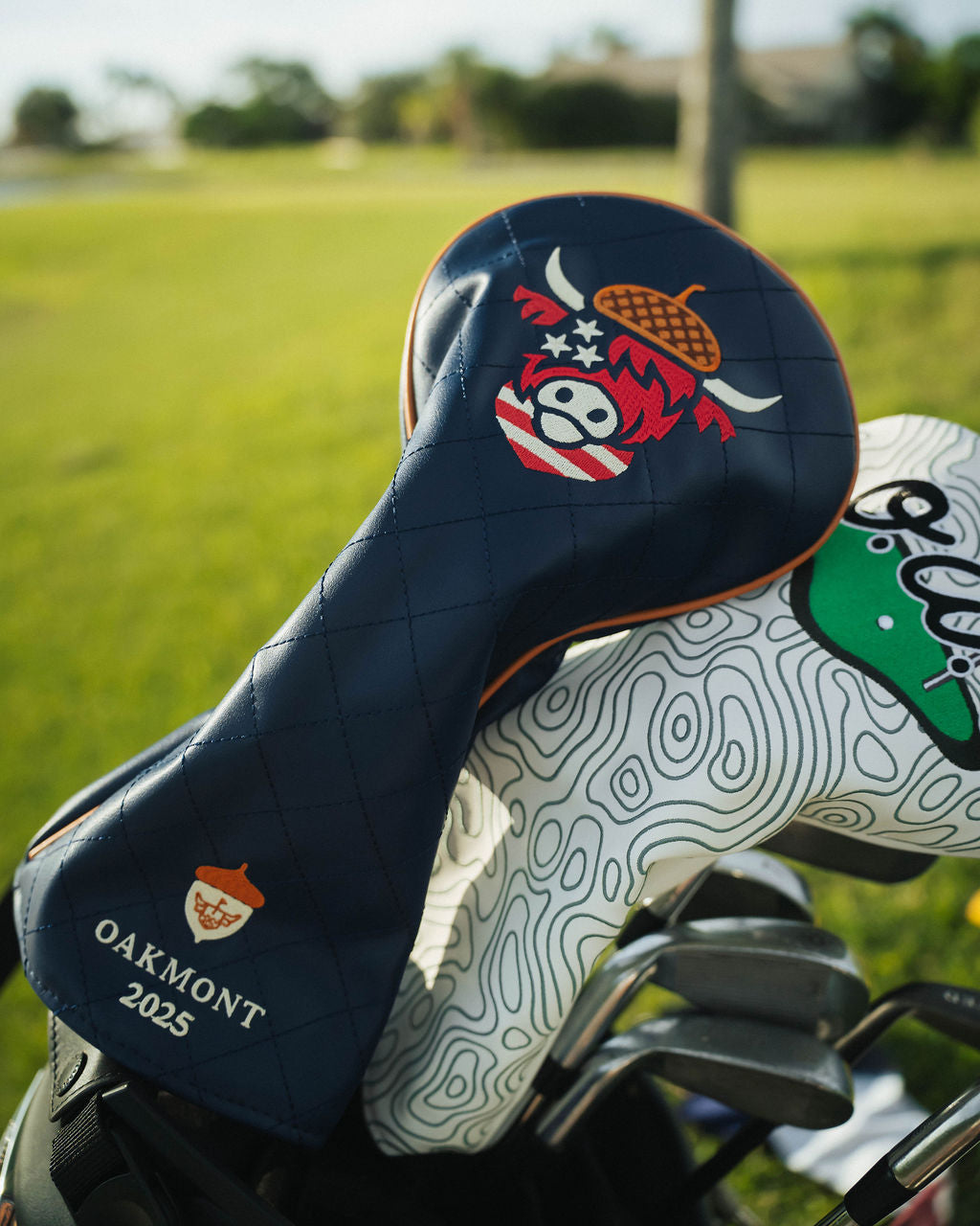 Oakmont 2025 golf gear collection featuring driver headcover, ball marker, and towel