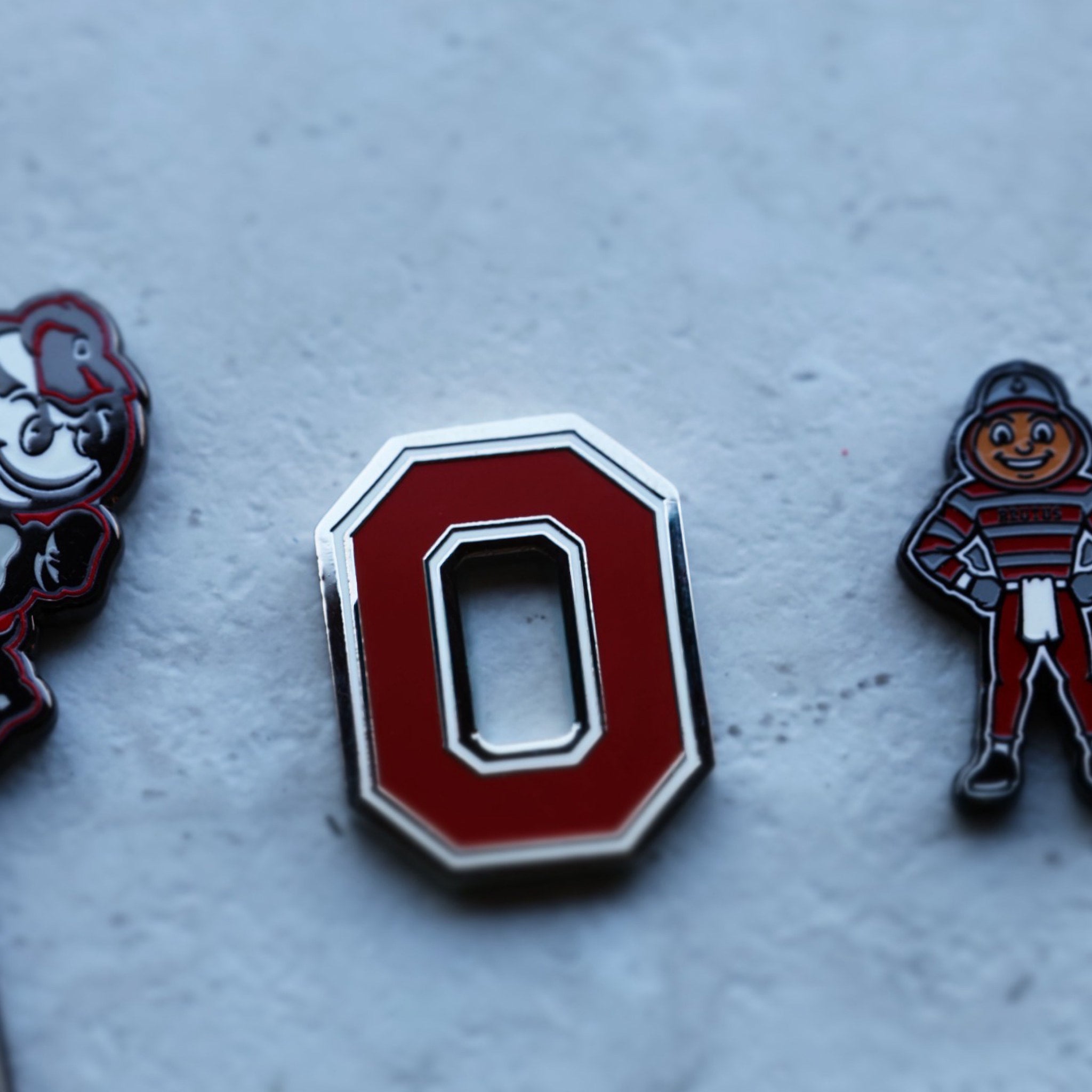 Ohio State Block O ball marker photographed on textured surface