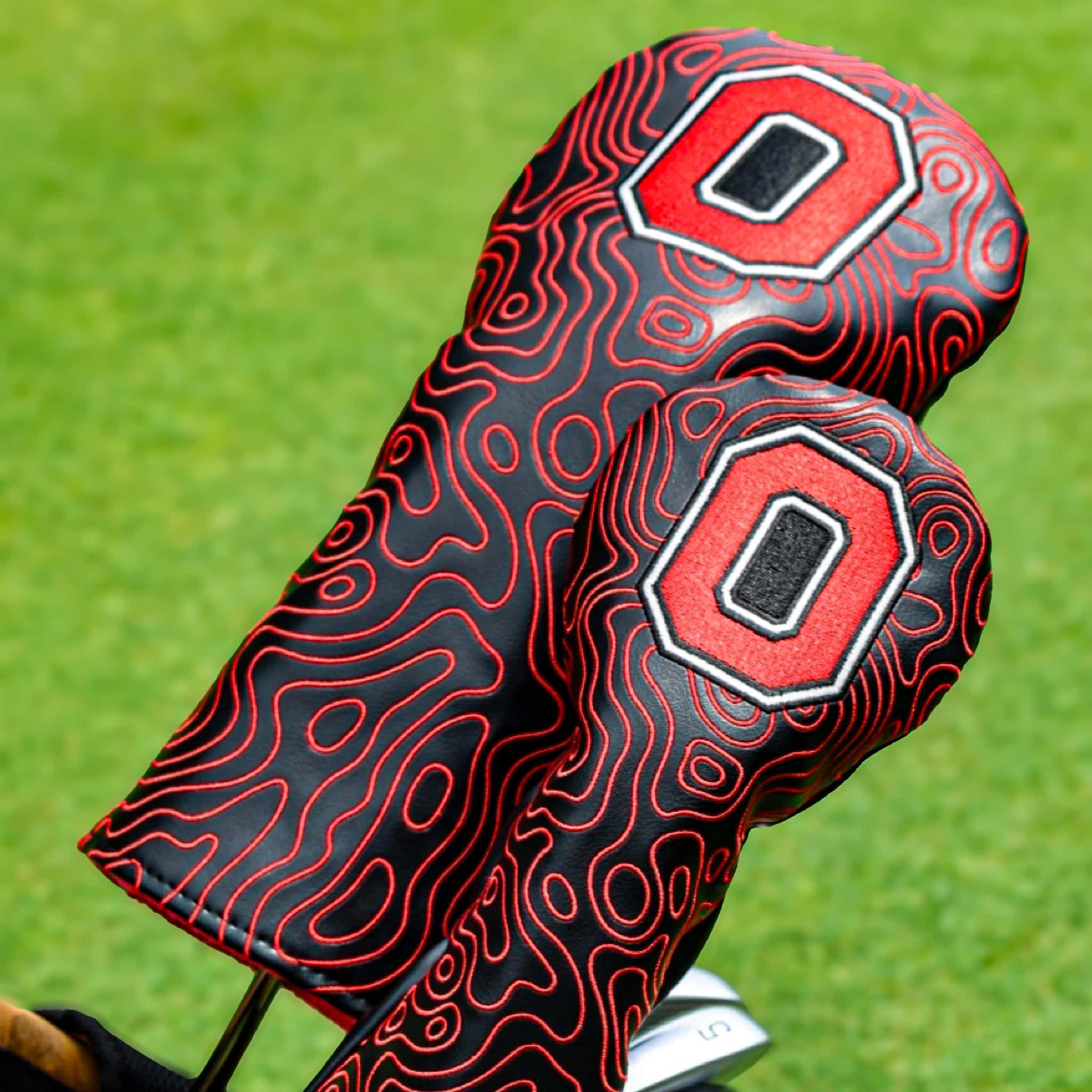 Official Ohio State Block O driver and fairway wood golf headcovers featuring a black and scarlet topographic pattern design.