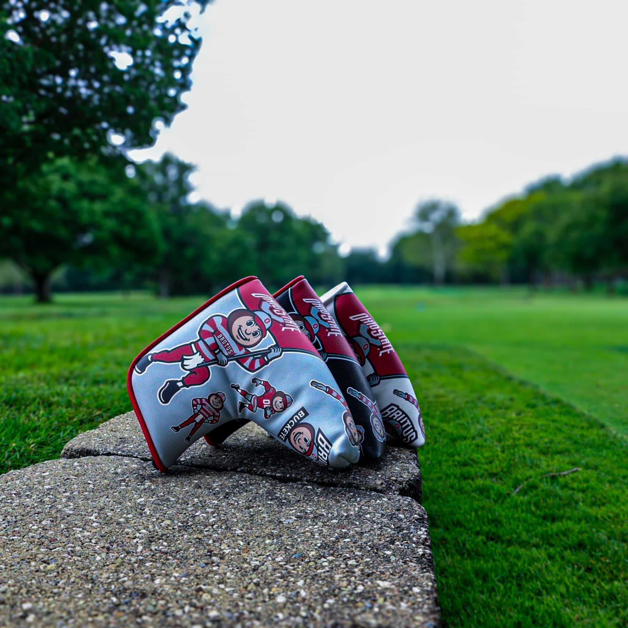 Ohio State Brutus blade putter headcover displayed on a golf course featuring officially licensed Buckeyes graphics.