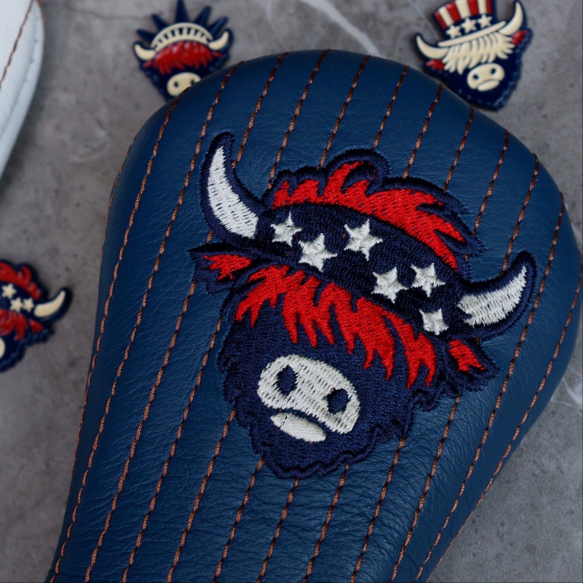 Detailed angled view of The Patriot Hybrid Headcover with navy leather construction and Americana-inspired Looper embroidery