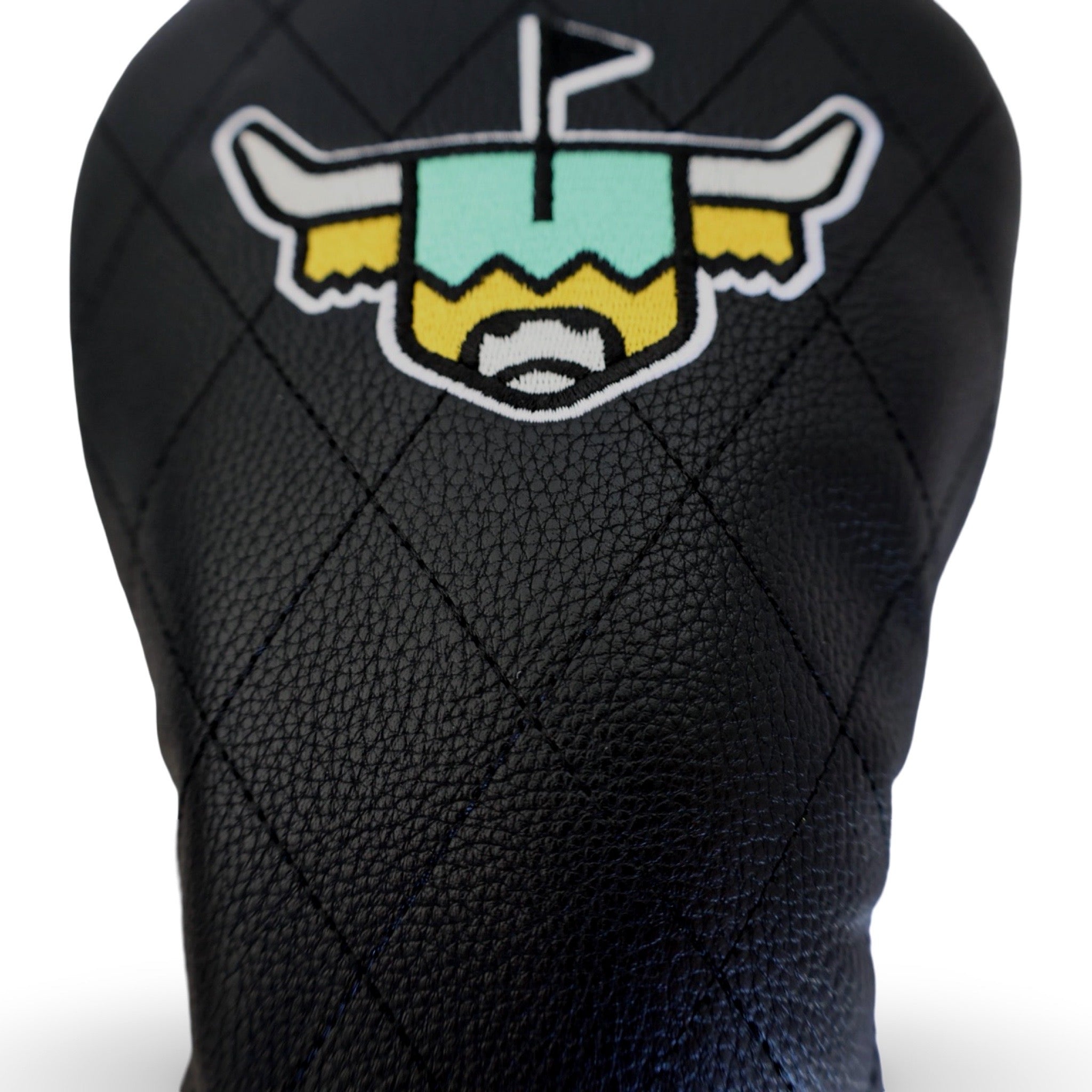 Close-up of the Quilted Heritage Leather Driver Headcover showing premium black pebbled leather, diamond quilt stitching, and embroidered Looper logo.