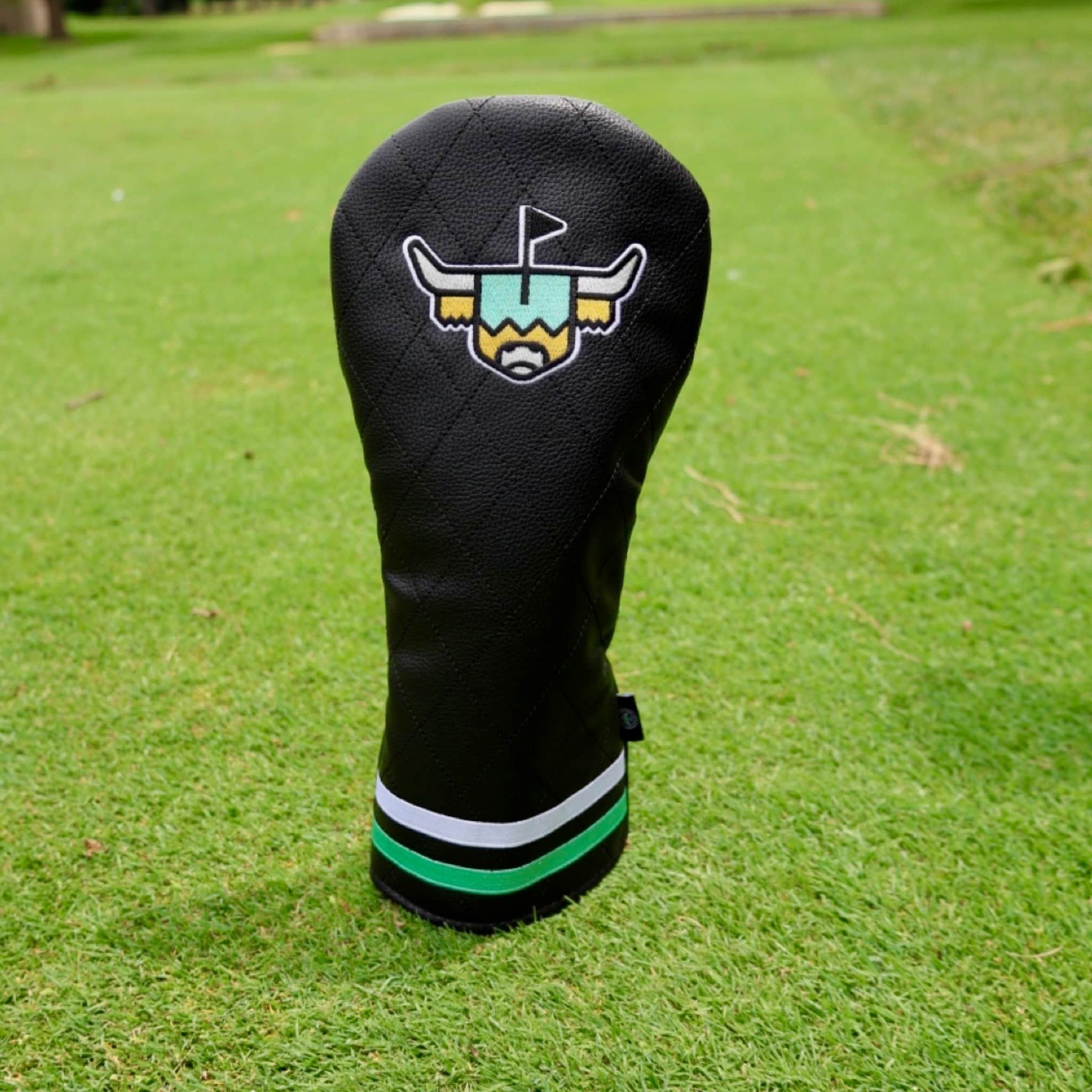Quilted Heritage leather driver headcover displayed on a golf course featuring premium quilted black leather construction by Caddy Collective Culture.