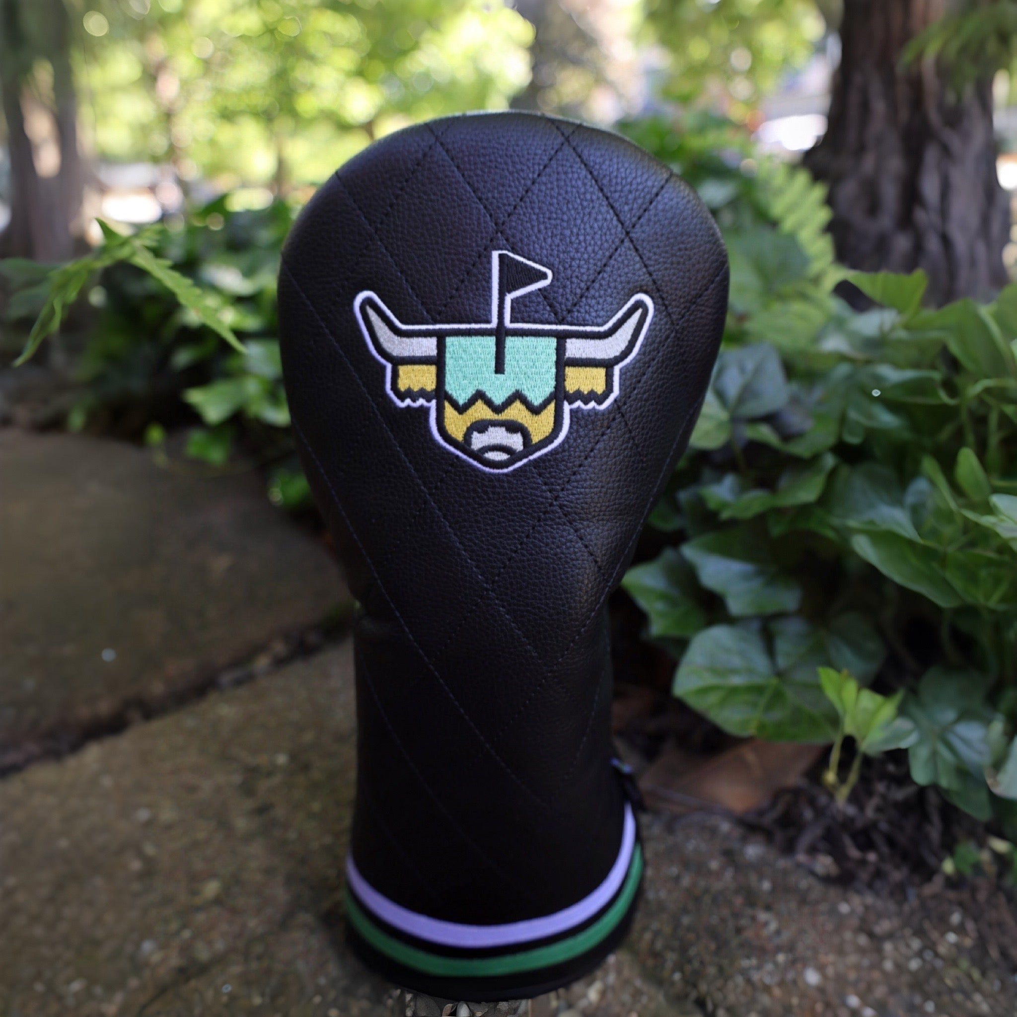 Quilted Heritage Leather Driver Headcover photographed outdoors featuring black quilted leather, embroidered Looper logo, and premium golf craftsmanship.