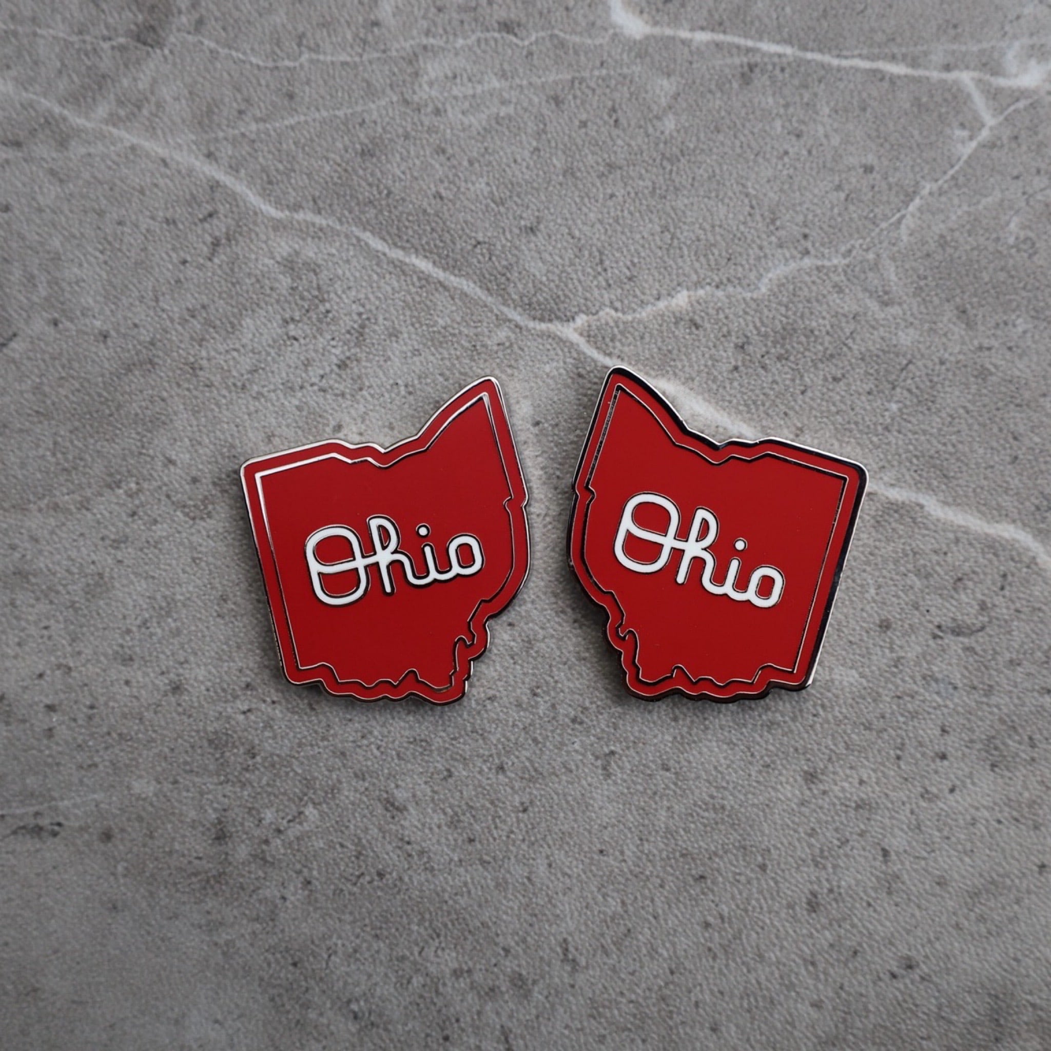 Script Ohio golf ball marker pair showing detailed enamel and magnetic finish