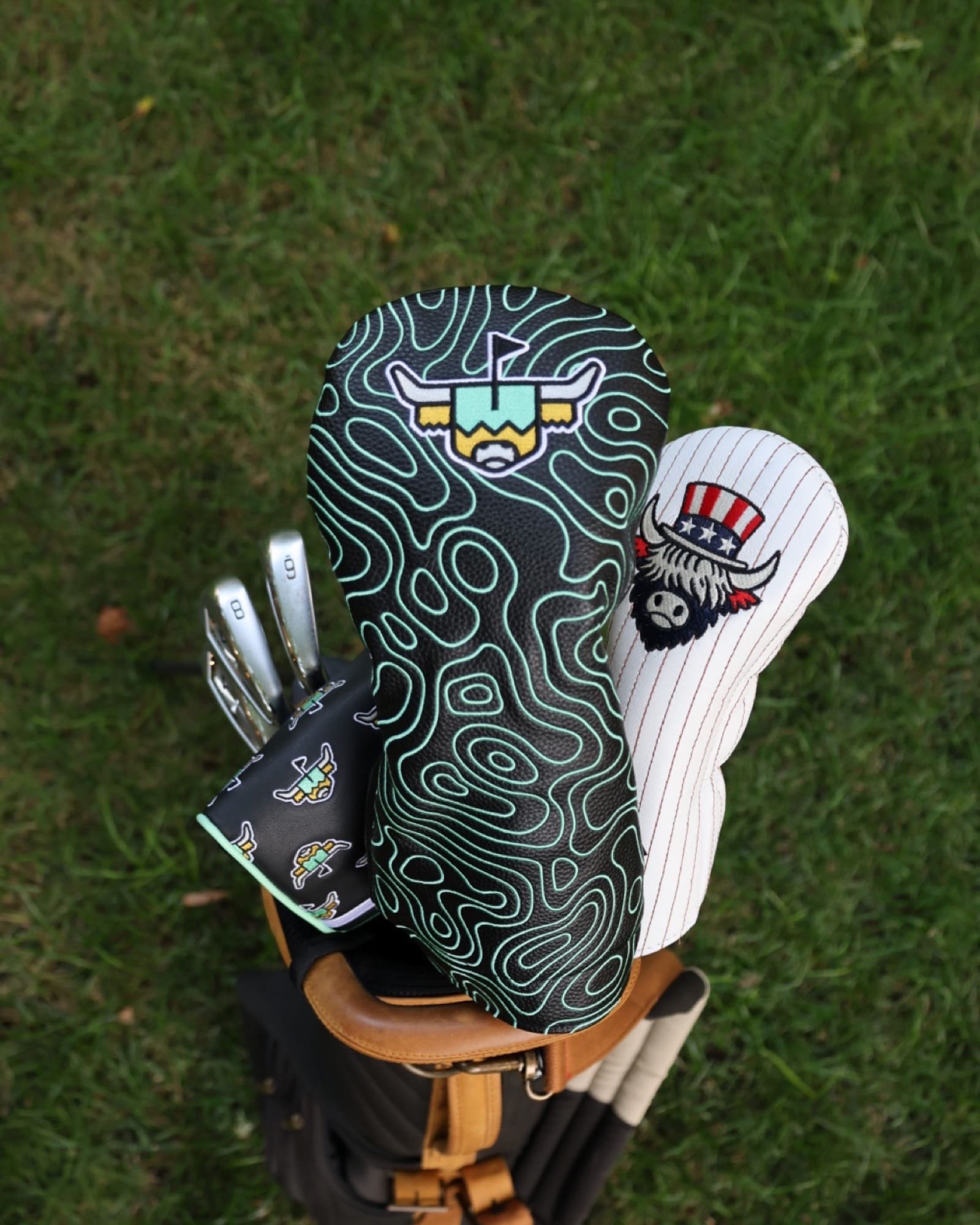 Terrain Driver Headcover – Midnight displayed on a golf bag with matching Caddy Collective Culture headcovers on the course.