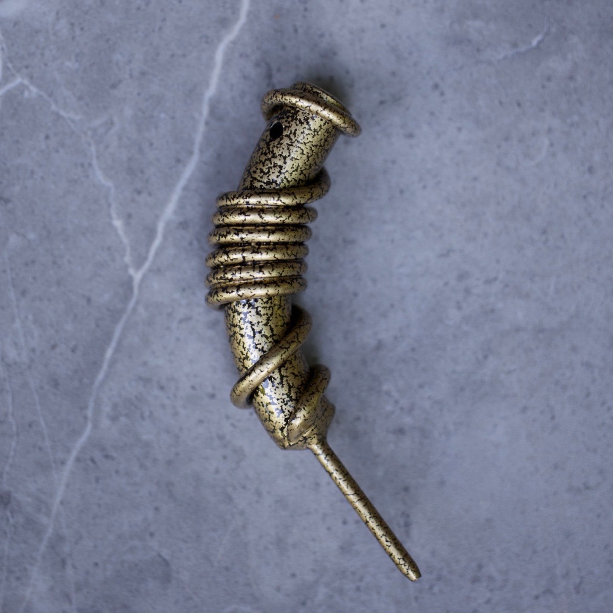 Hand-forged Forged Gold single prong golf divot tool featuring twisted coil detailing and textured industrial finish from Caddy Collective Culture.