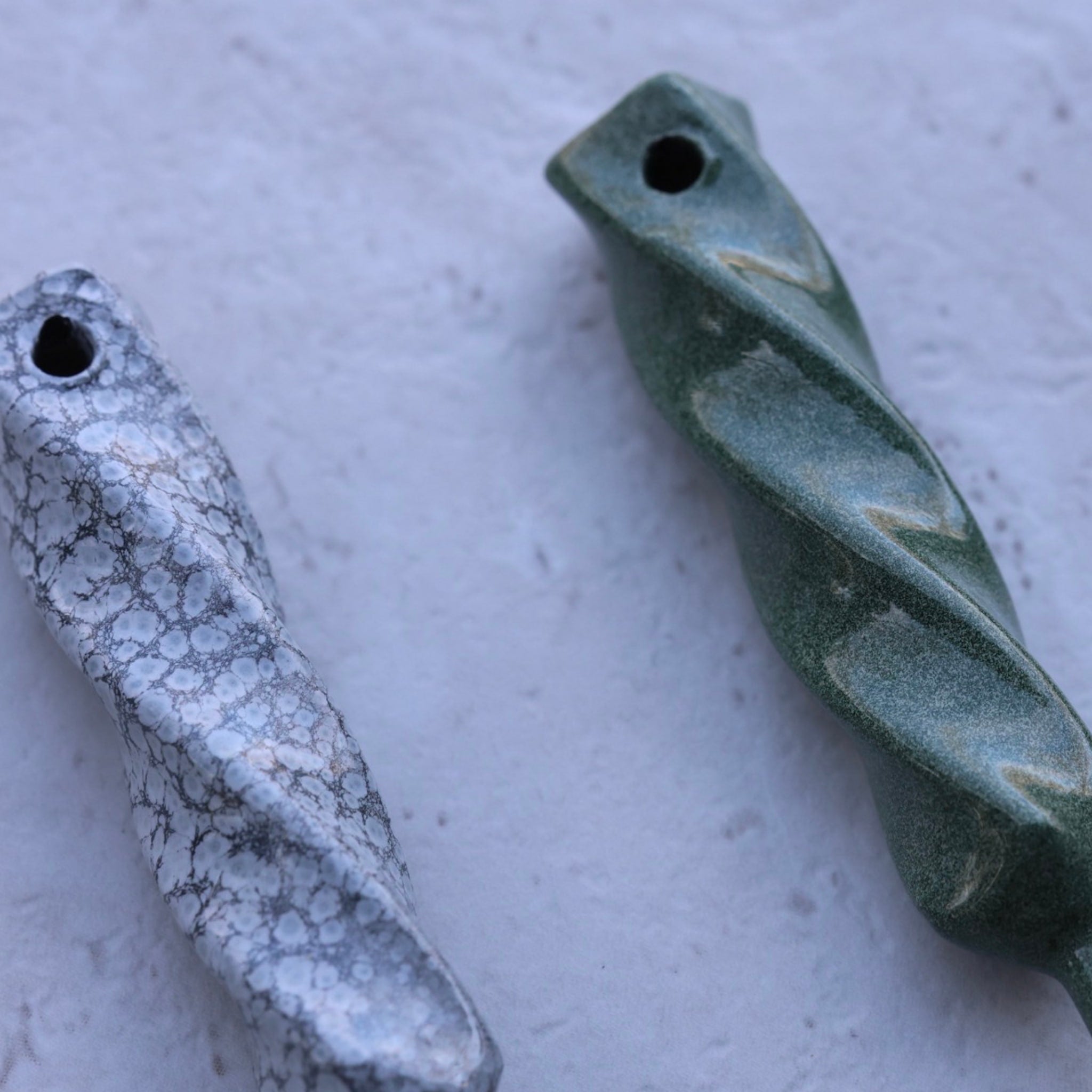 Twisted Metal single prong divot tools photographed on light stone surface emphasizing handcrafted metal textures