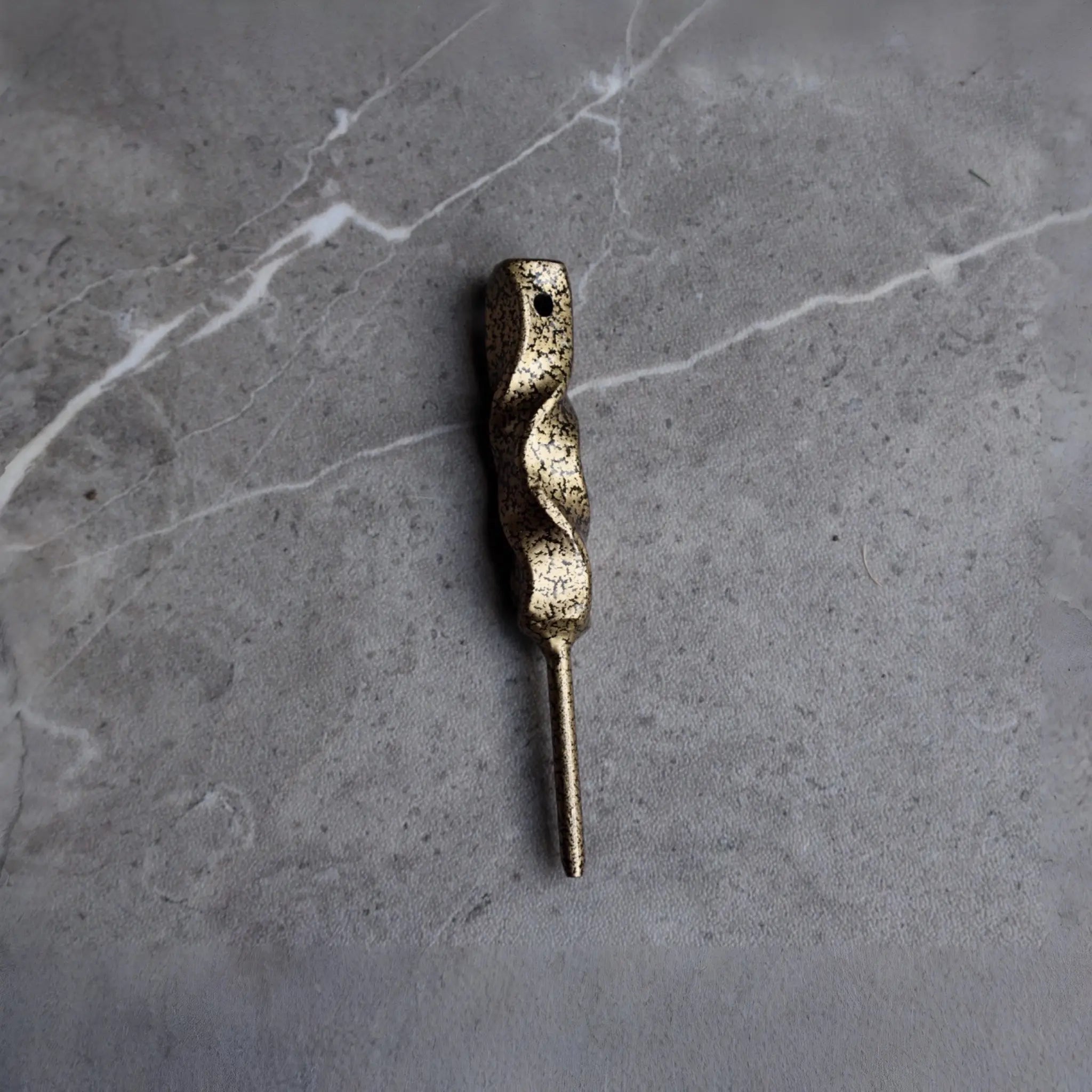Front view of the Twisted Column Golf Divot Tool featuring a hand-forged twisted steel body with an antique gold finish.