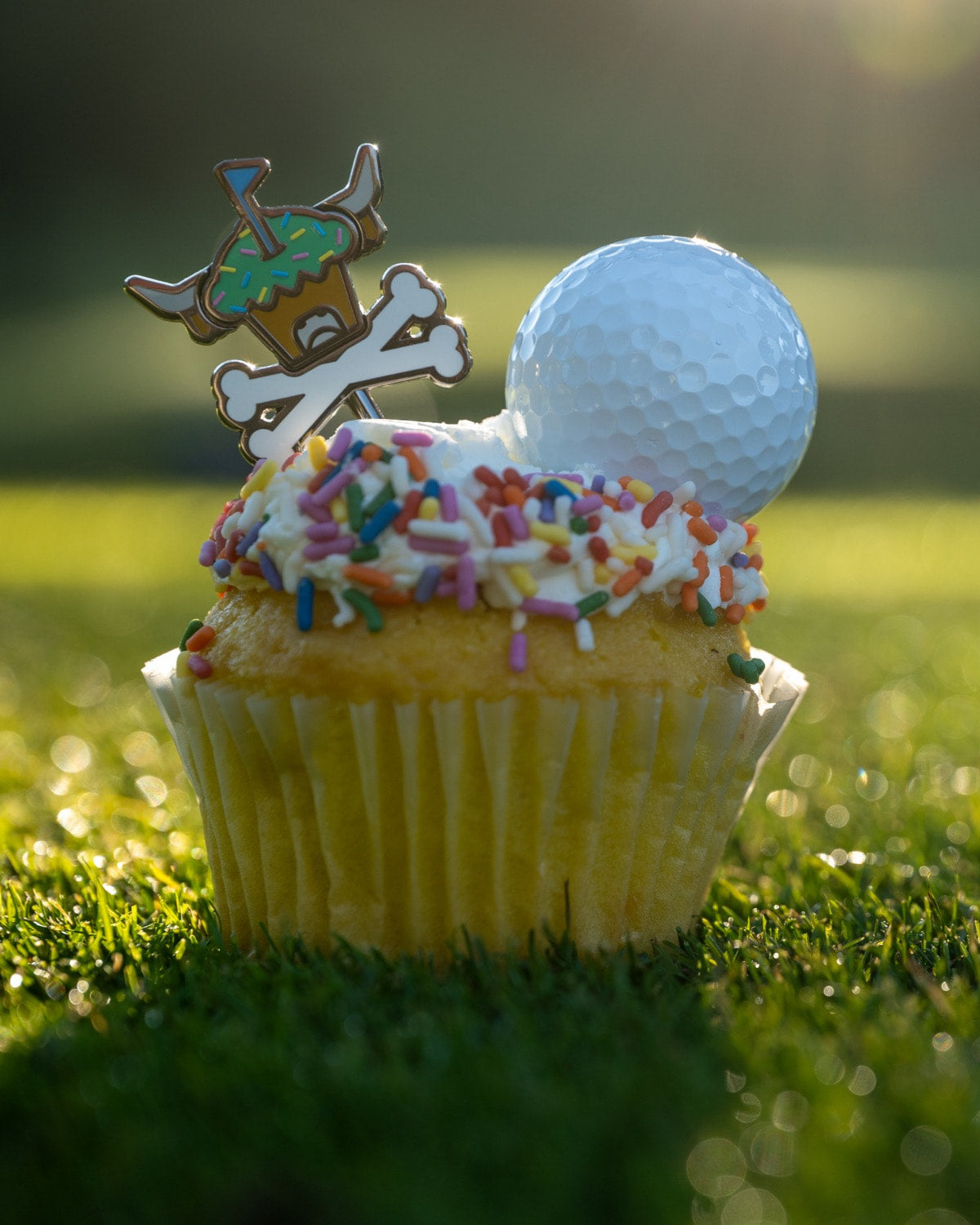 Johnny Cupcakes × Caddy Collective Culture limited-edition golf collection featuring Looper logo headcovers, towel, divot tool, ball marker, and collectible packaging.”