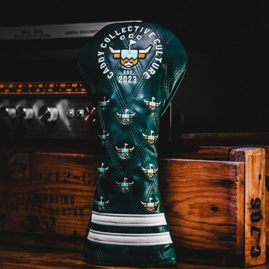 Caddy Collective Culture green quilted leather golf headcover featuring the Looper logo embroidery, displayed on a wooden background.