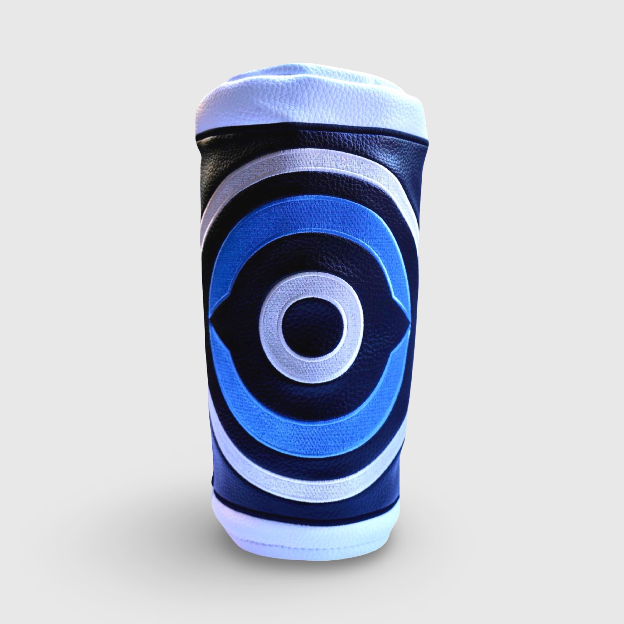 Front view of the Fore Eye leather driver headcover showing layered blue, white, and black concentric embroidery