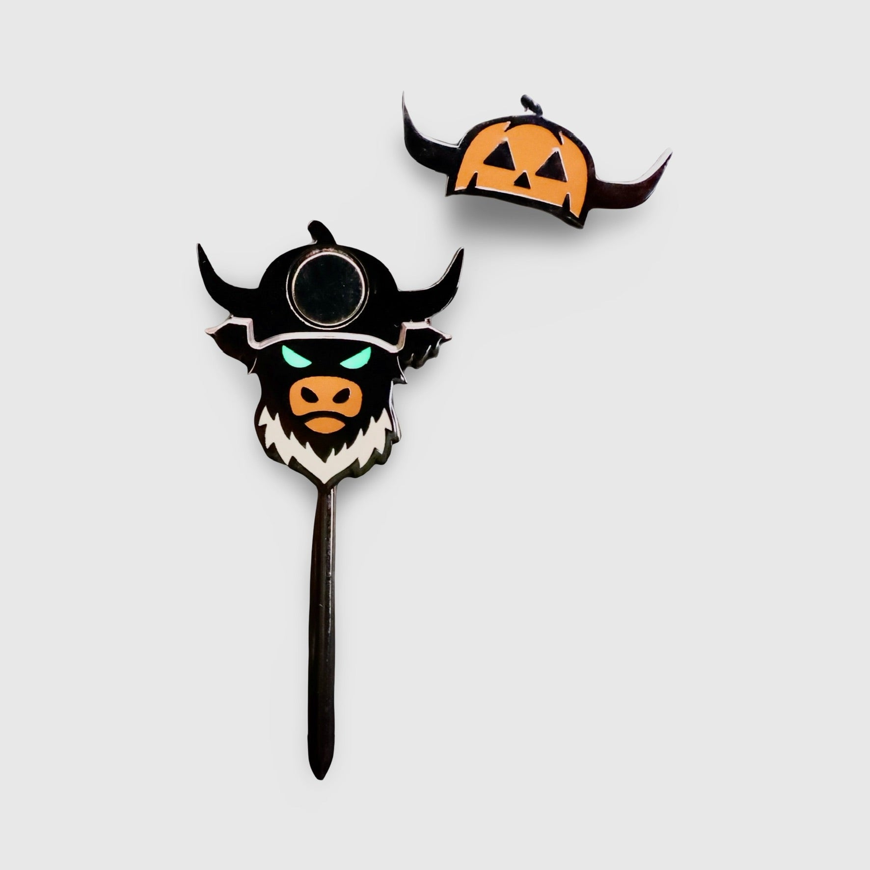 Caddy Collective Culture Looper After Dark Halloween divot tool and ball marker set featuring black Looper design with glow-in-the-dark green eyes and removable pumpkin hat marker on burnt orange background.