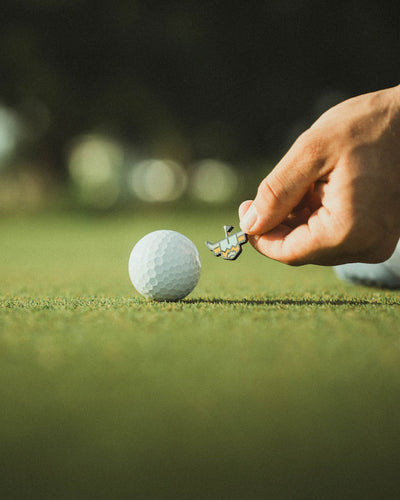 Double-sided golf ball marker putting green alignment on green