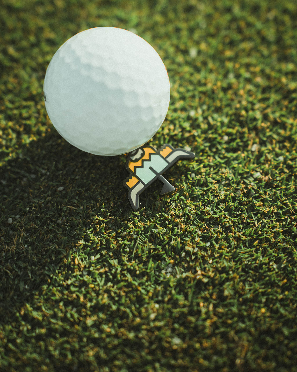 Double-sided golf ball marker putting green alignment on green with ball