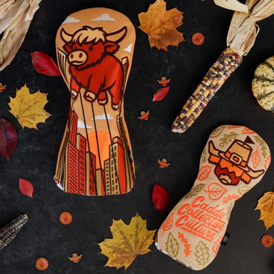 Full view of the Harvest Parade driver headcover showing the Looper parade balloon and cityscape artwork.