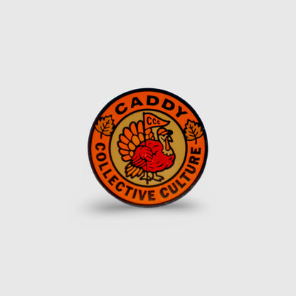 Harvest Turkey ball marker by Caddy Collective Culture featuring a Thanksgiving turkey design with fall leaves and CCC branding.
