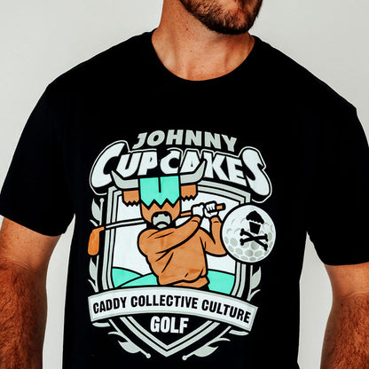 Model wearing Johnny Cupcakes x CCC golf T-shirt, golfer logo visible

