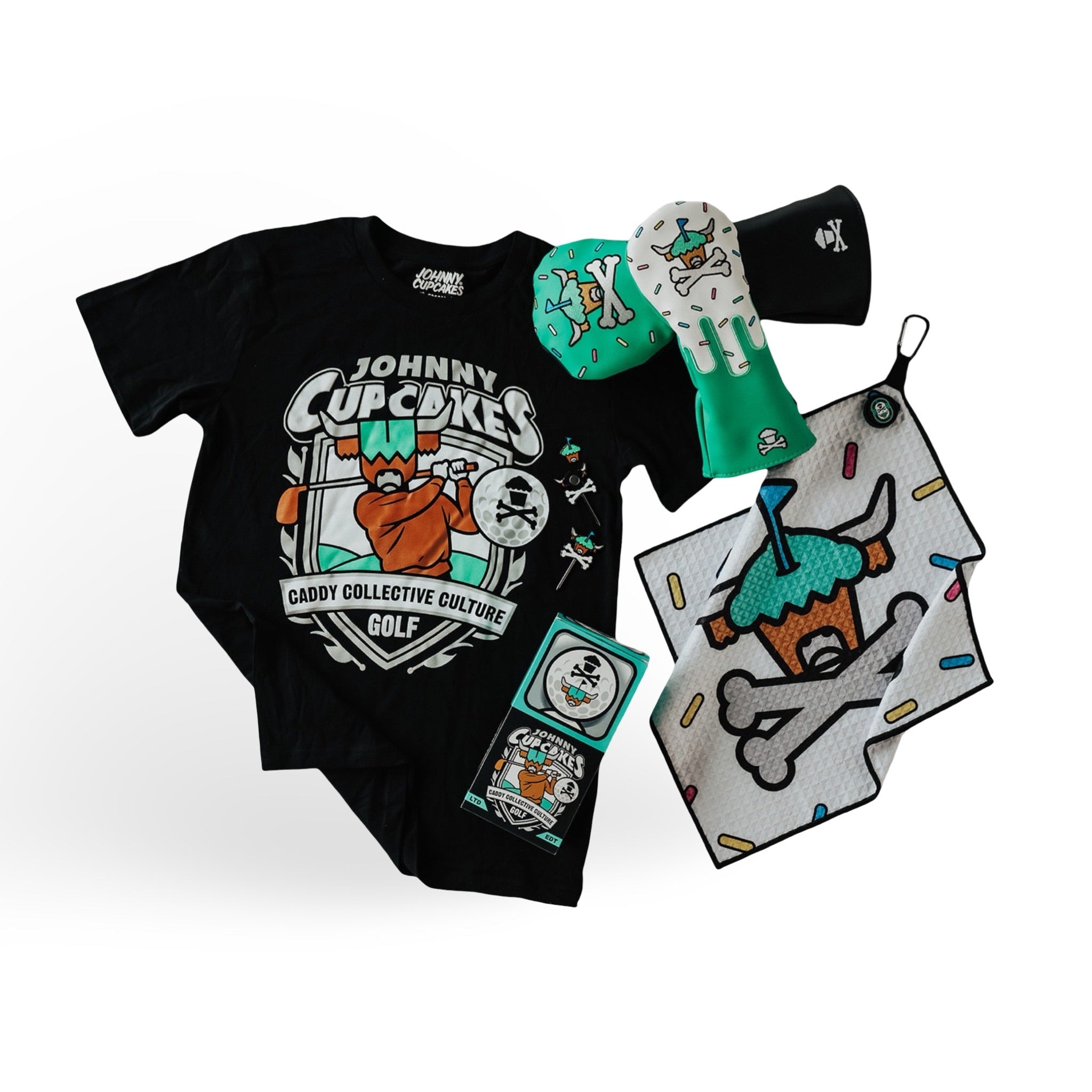 Johnny Cupcakes The Hole Batch golf collection featuring headcovers, towel, divot tool, ball markers, and graphic tee by Caddy Collective Culture