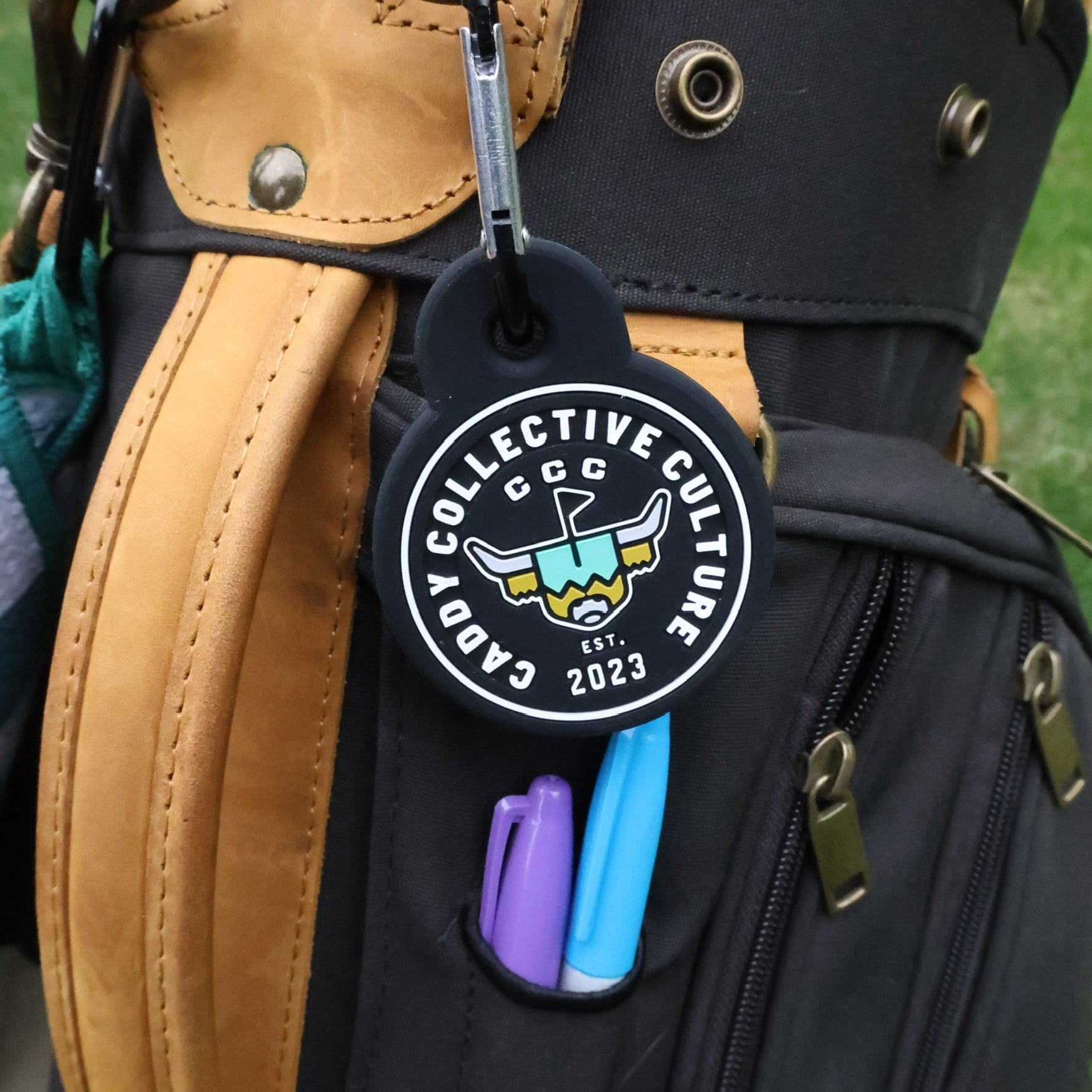 The Link magnetic towel attachment clipped to a golf bag showing CCC Looper logo.branding.