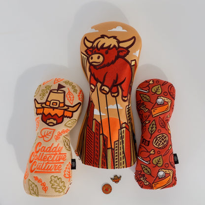Pilgrim Looper ball marker by Caddy Collective Culture displayed with matching Thanksgiving headcovers in a bright flat-lay scene.