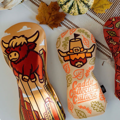 Pilgrim Looper fairway headcover photographed with matching Caddy Collective Culture Thanksgiving headcovers in a seasonal flat-lay scene.