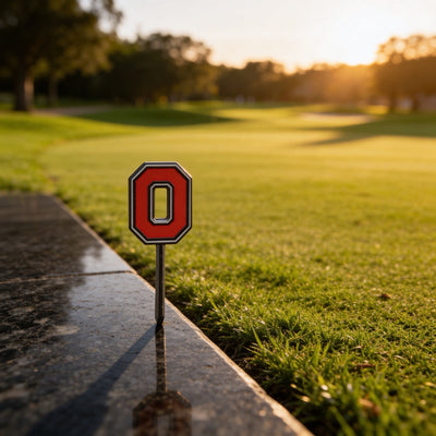 THE Block O Divot Tool with Ohio State red Block O logo photographed at sunset on golf course by Caddy Collective Culture