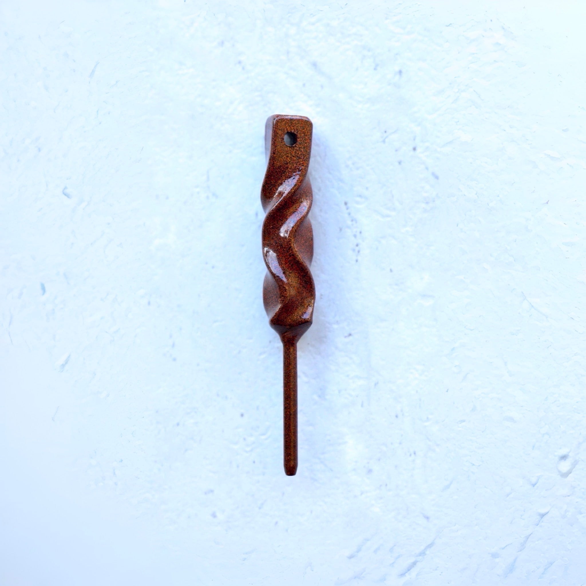 Dual-Twist divot tool in rustic green finish from the Twisted Metal collection, shown straight on against a textured white background.