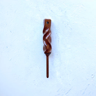 Dual-Twist divot tool in rustic green finish from the Twisted Metal collection, shown straight on against a textured white background.