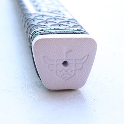 End cap of CCC x Garsen Quad Tour putter grip featuring embossed Looper icon