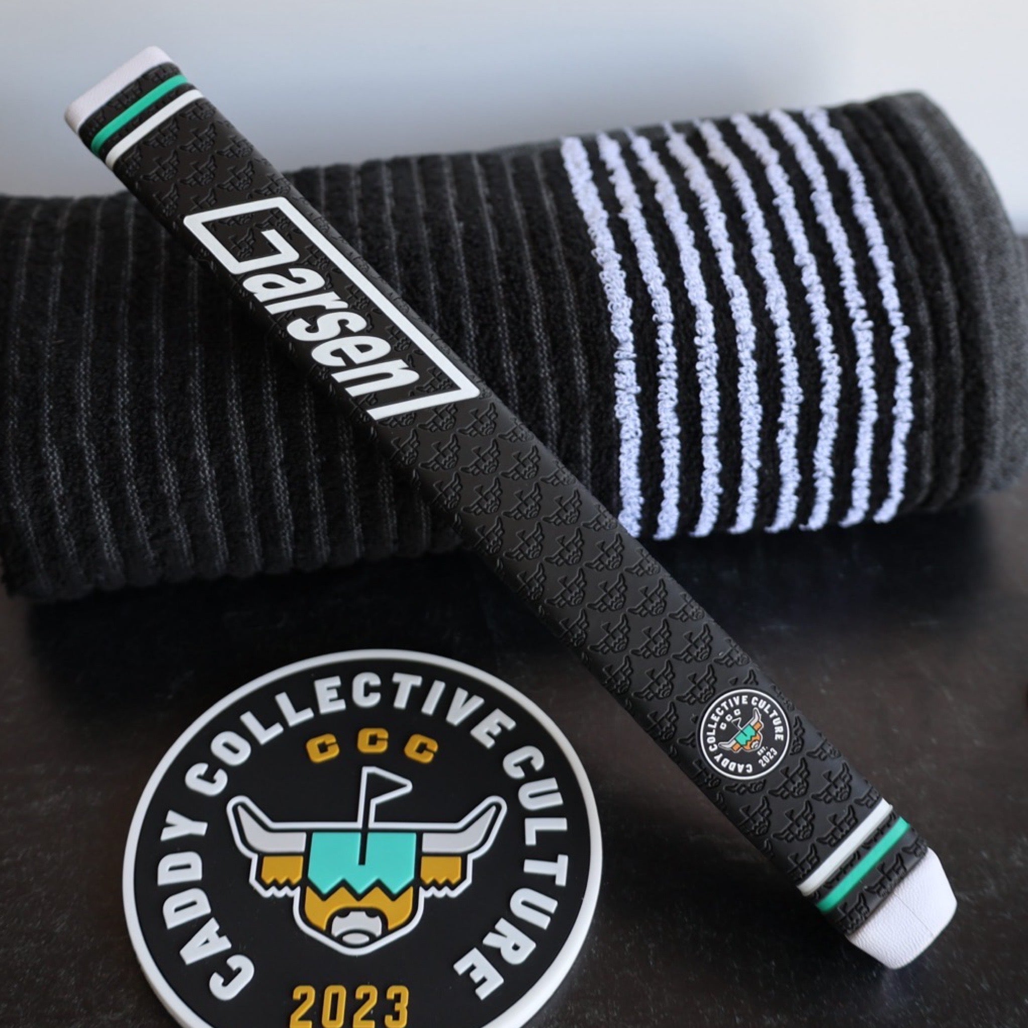 CCC x Garsen Quad Tour putter grip styled with Caddy Collective towel and logo practice disc