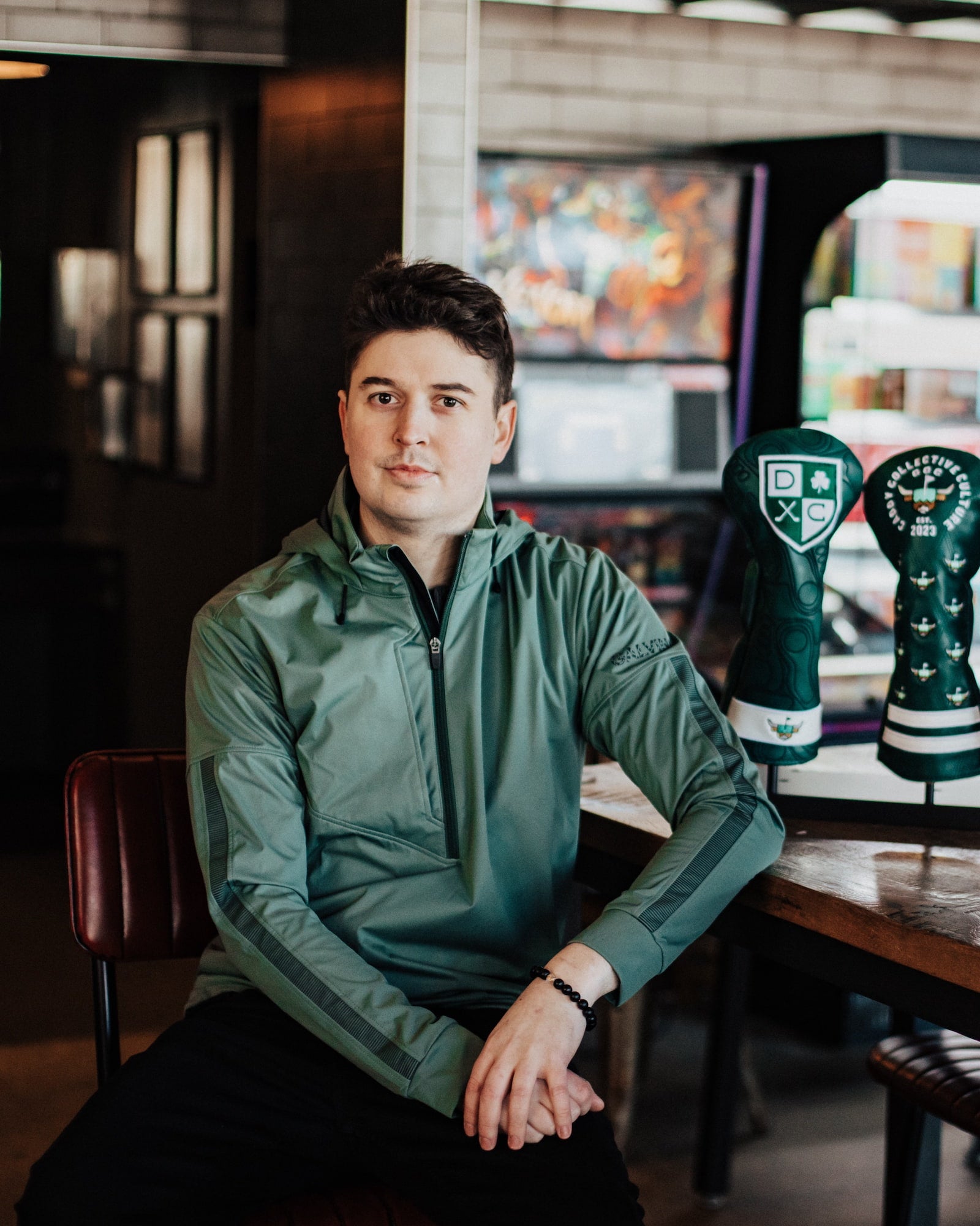 Collin Jenkins, founder of Caddy Collective Culture, photographed in a quiet, editorial setting with handcrafted golf headcovers.