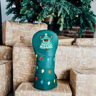 Evergreen driver headcover displayed indoors with a decorated Christmas tree in the background.