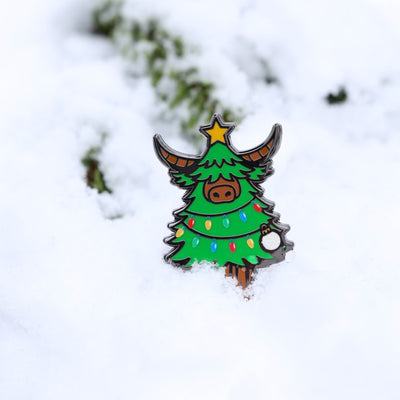 Artistic photo of the Evergreen Looper divot tool in snow with soft-focus background.