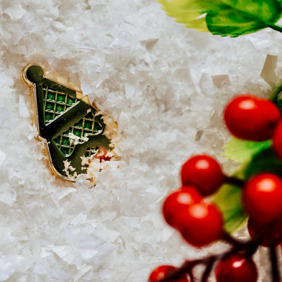 Artistic soft-focus photo of the Santa Silhouette ball marker resting in snow with blurred winter background.