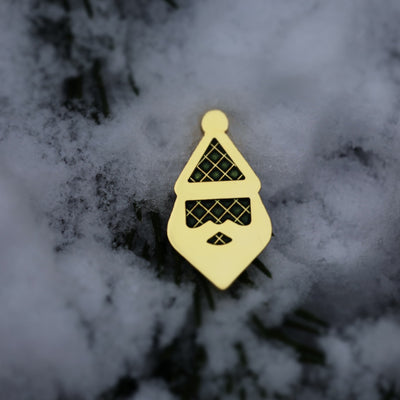 Santa Silhouette golf ball marker partially set in fresh snow.